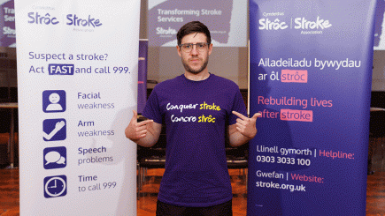 Michael in front of Stroke Association banners