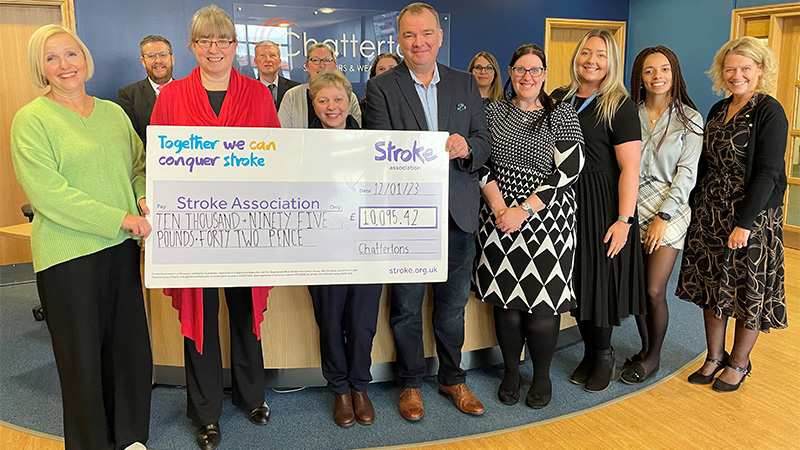 Group of people from Chattertons holding a large cheque for the Stroke Association.