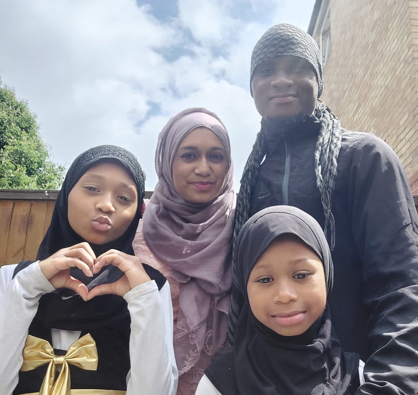 Janine, with her husband and children