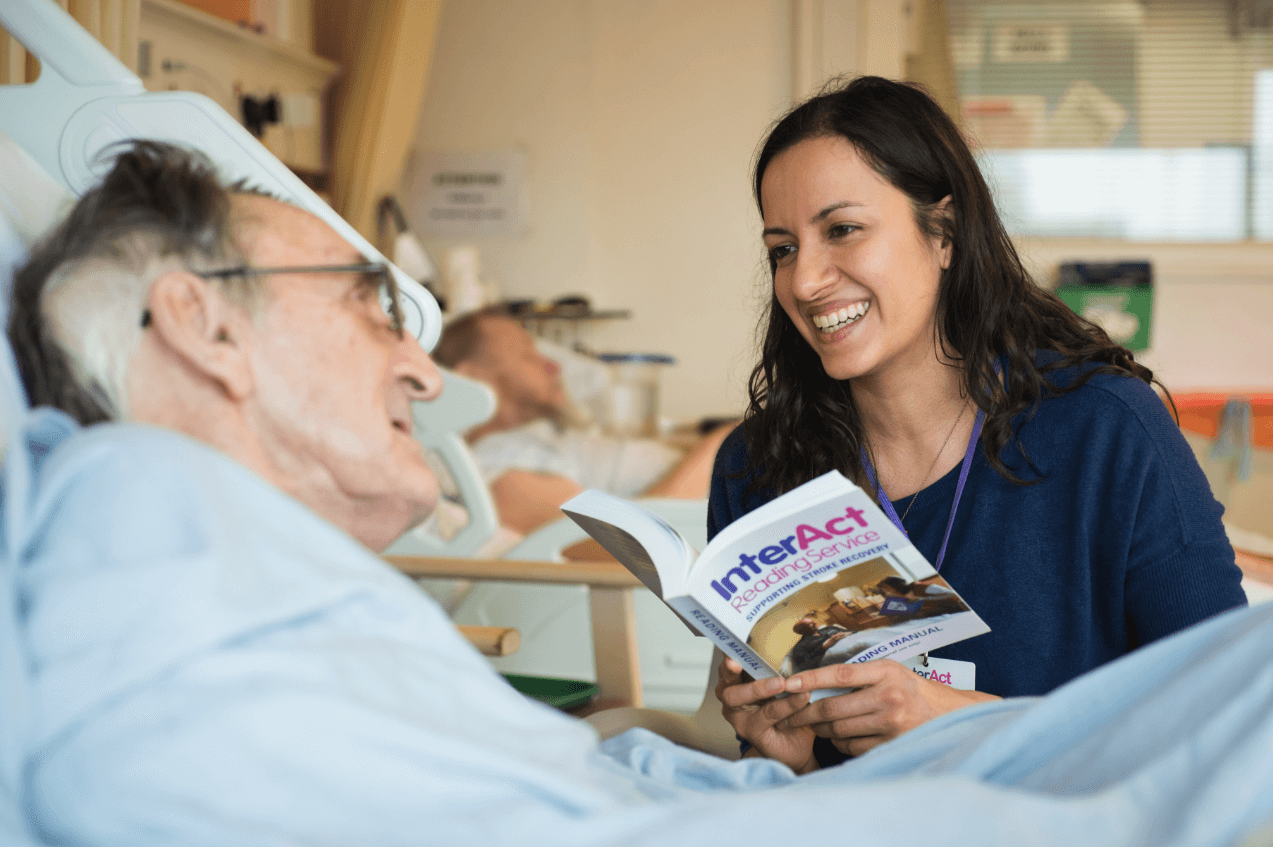 Image of woman visiting elderly man in hospital bed