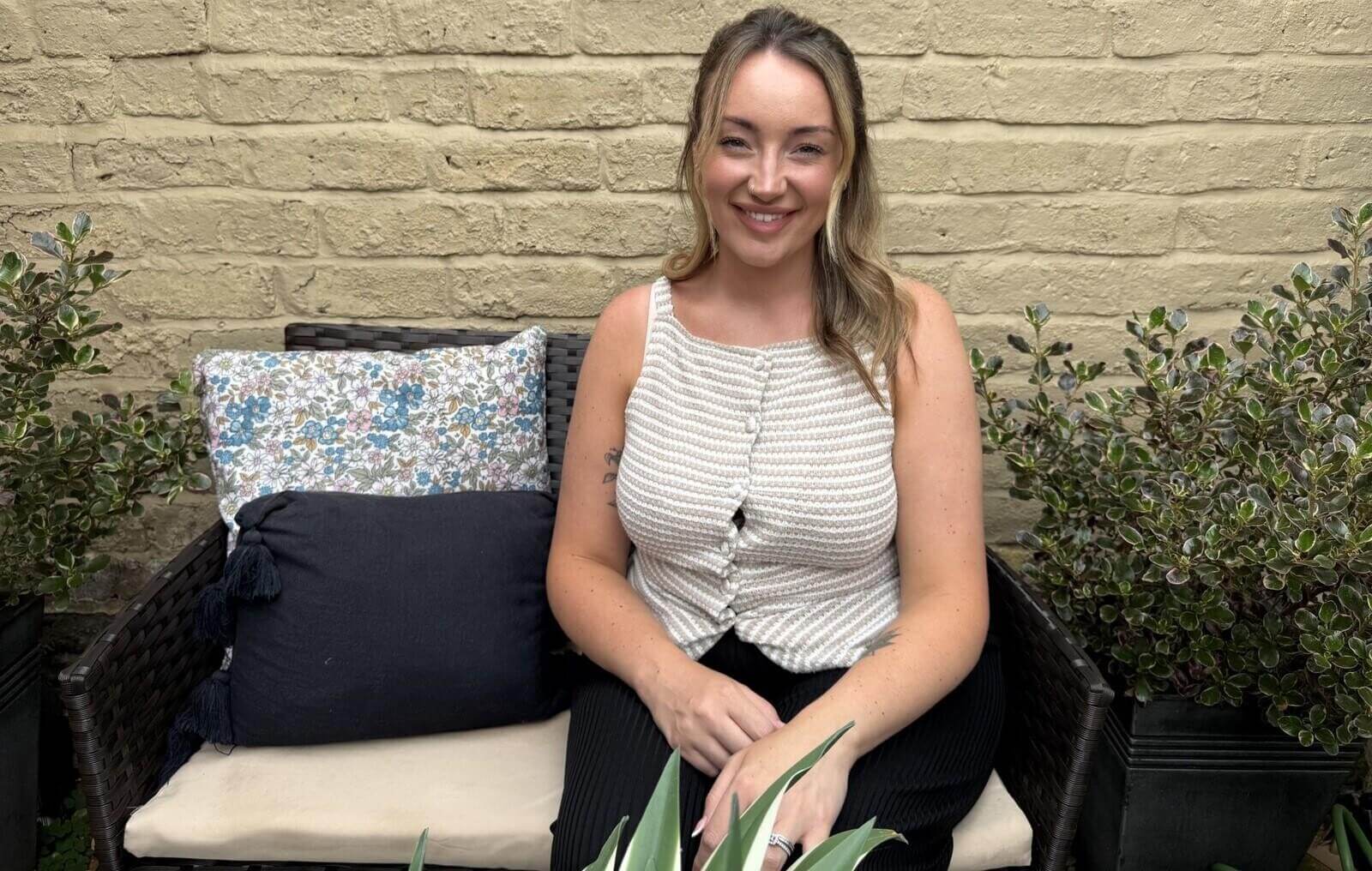 Stroke survivor Louise sitting in a garden chair