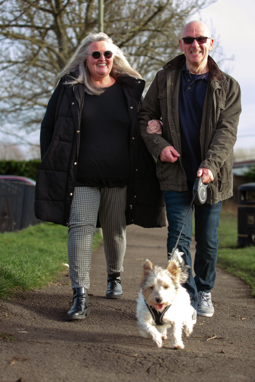 Paul and Miriam Doyle walking with dog