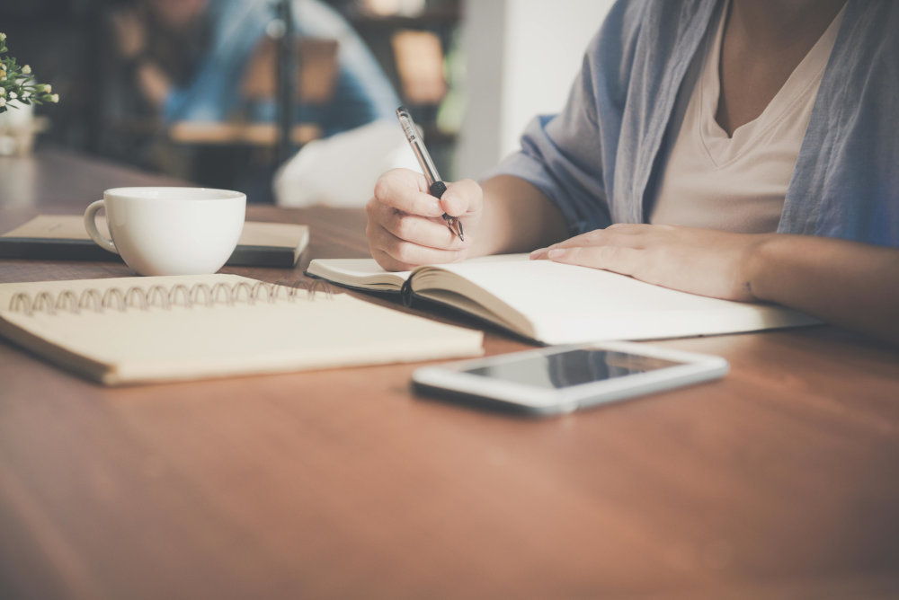 writing on notepad on table