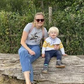 Photo of Rachel and Austin, sitting on a log
