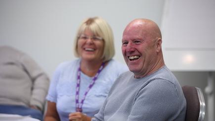 Two people laughing at a Stroke Group Network event