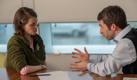 Ruth and Dr Terry talking at a table