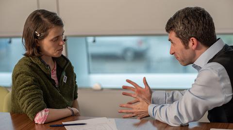 Ruth and Dr Terry talking at a table