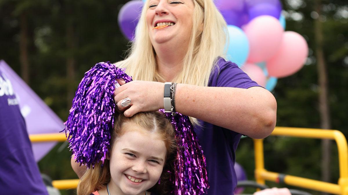 Woman doing young girl's hair at the Great North Run