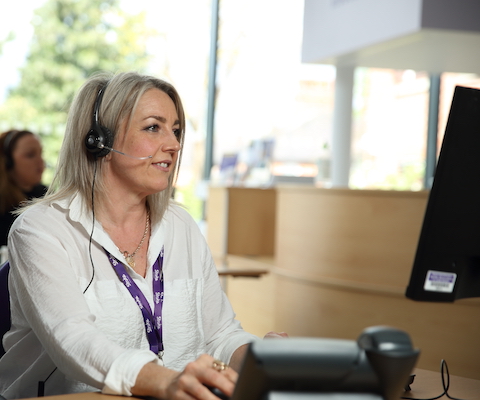 Photo of Helpline worker looking at her computer