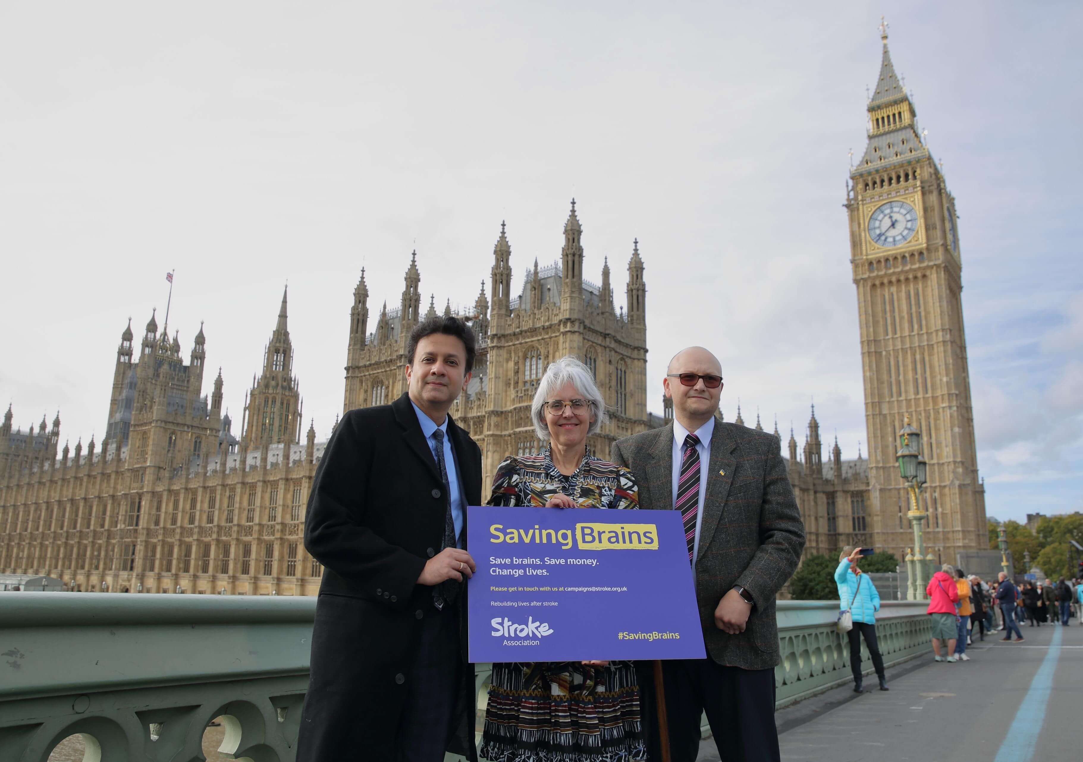 Juliet Bouverie stood by London parliament building with Saving brains campaign sign 