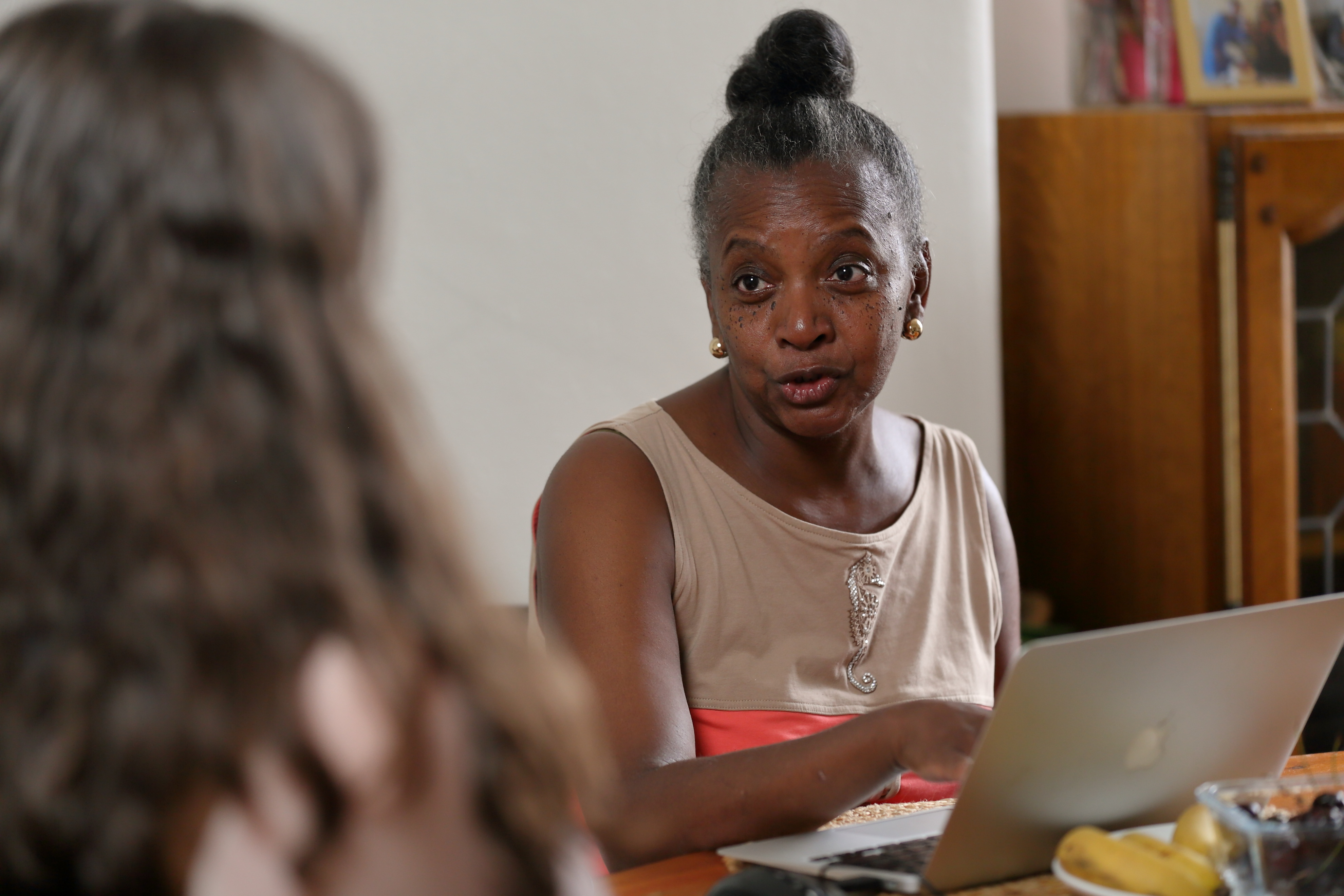 Person sitting at table with laptop