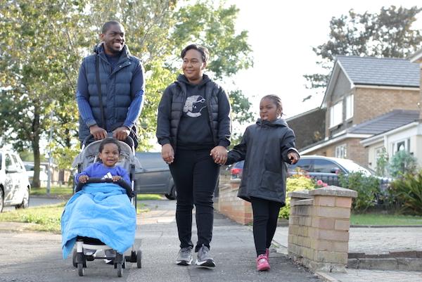 Alexander, a stroke survivor, walking with his wife and children