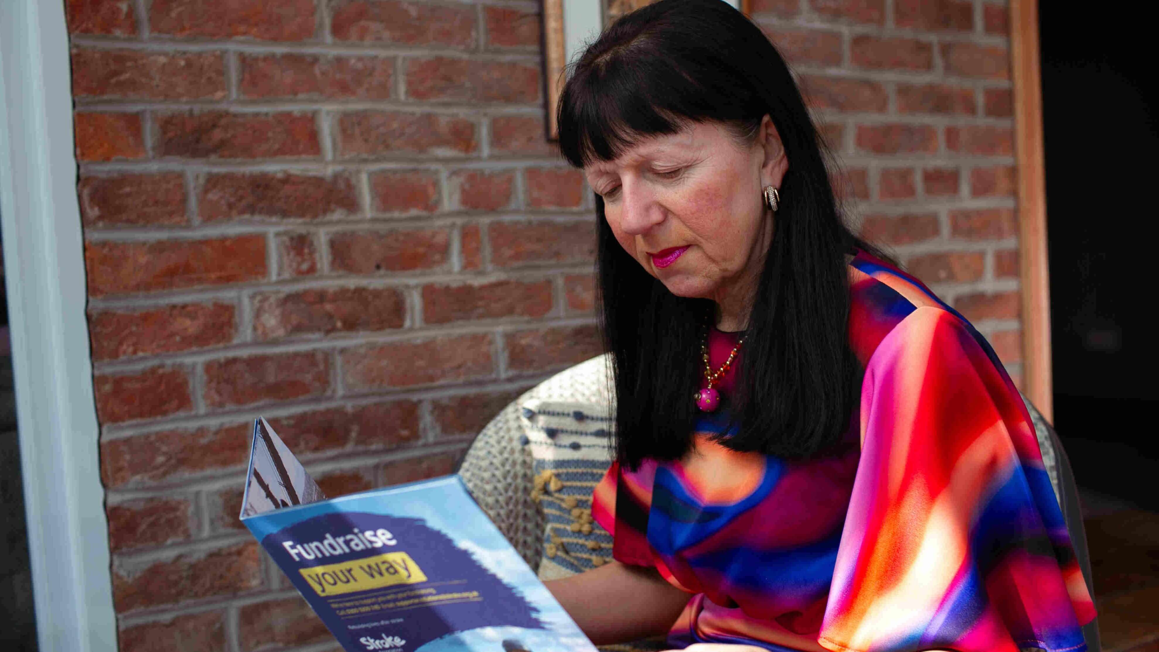Person holding fundraising magazine