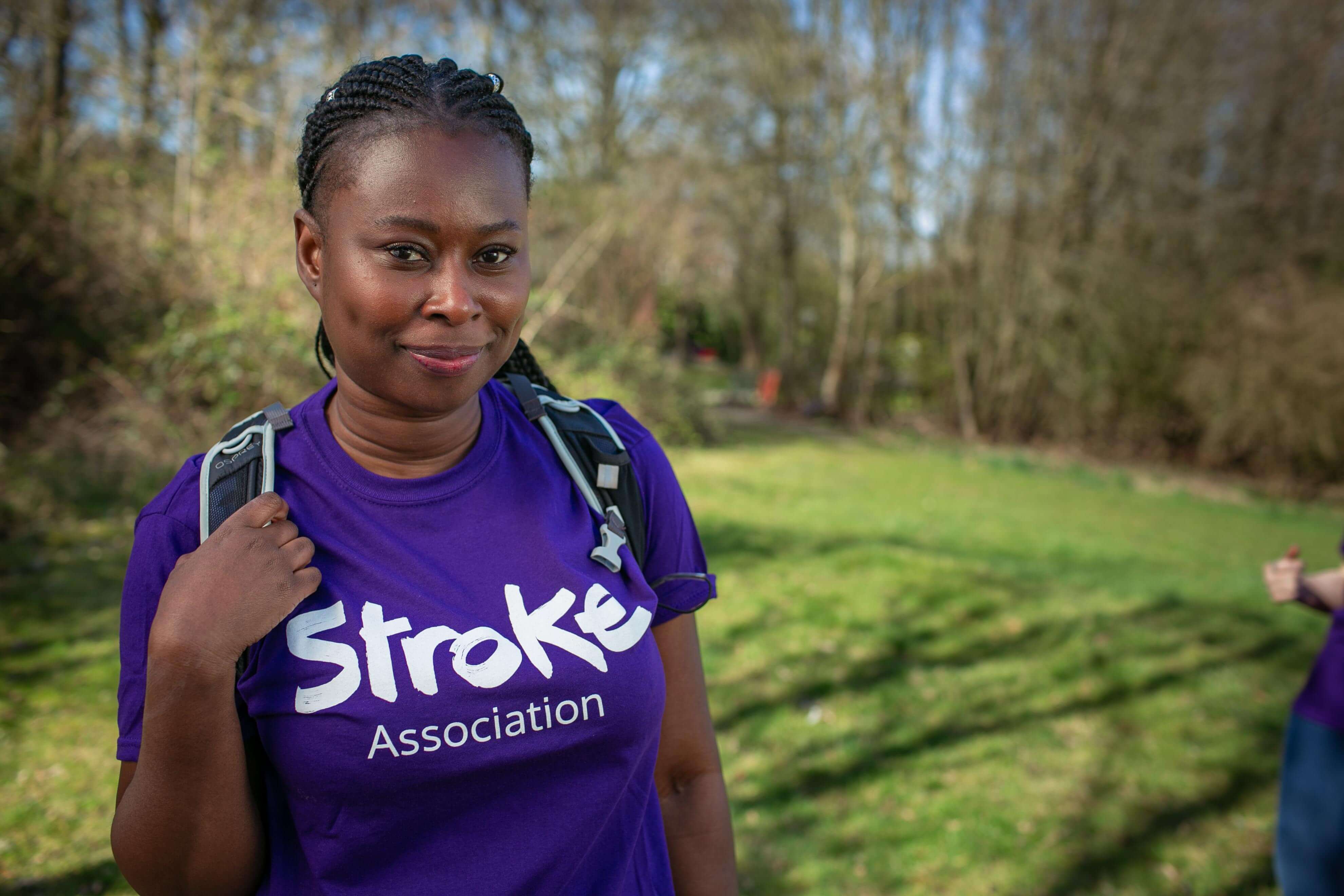 A photo of Lida looking at the camera with a purple Stroke Association tshirt on