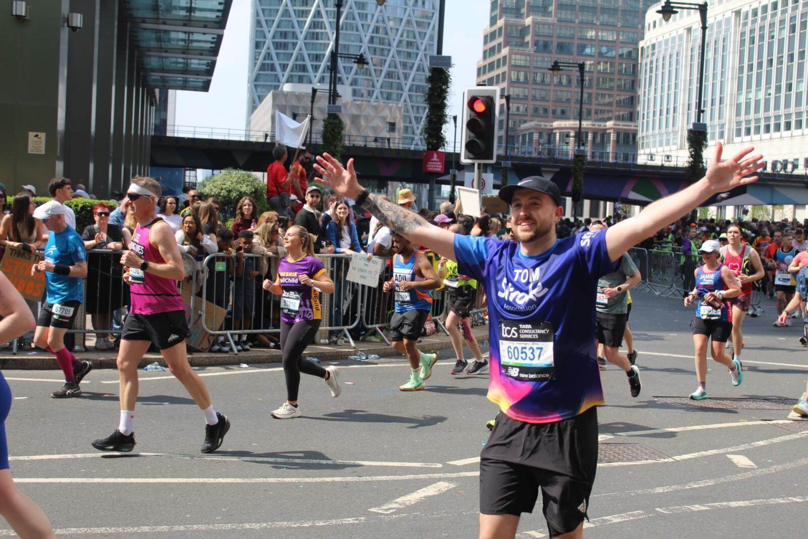 A Team Stroke runner celebrating at the London marathon