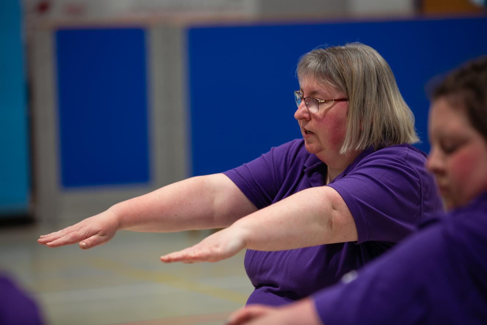 A woman raising her arms.