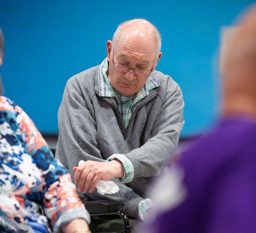 stroke survivor holding arm