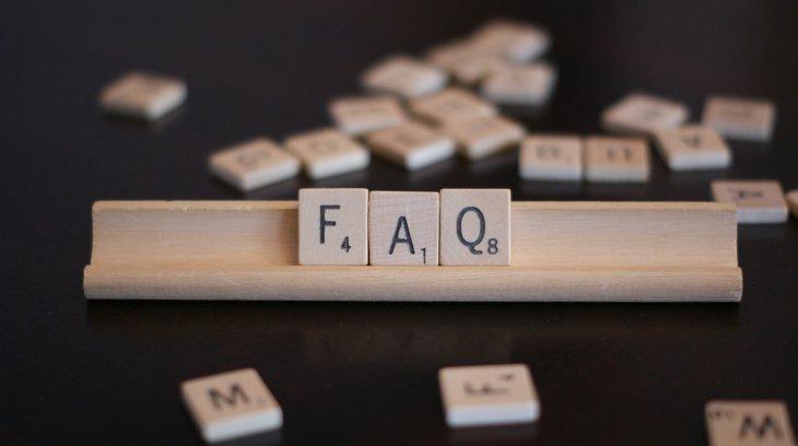 Wooden letter blocks spelling out FAQ - frequently asked questions