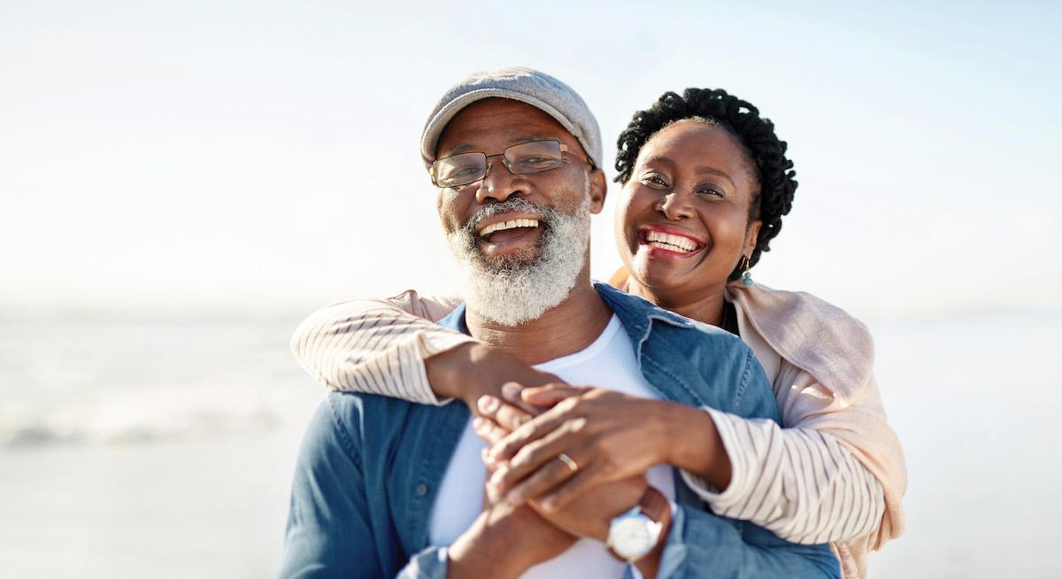 Stock photo of a couple on holiday, smiling at the camera