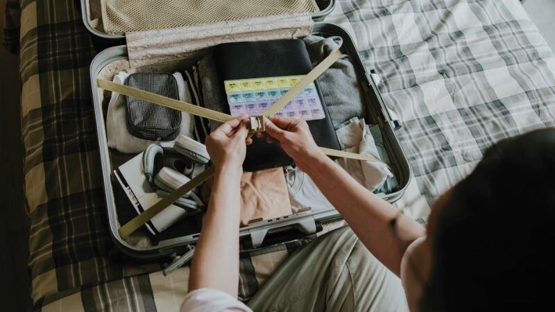 Stock photo of someone packing a suitcase.