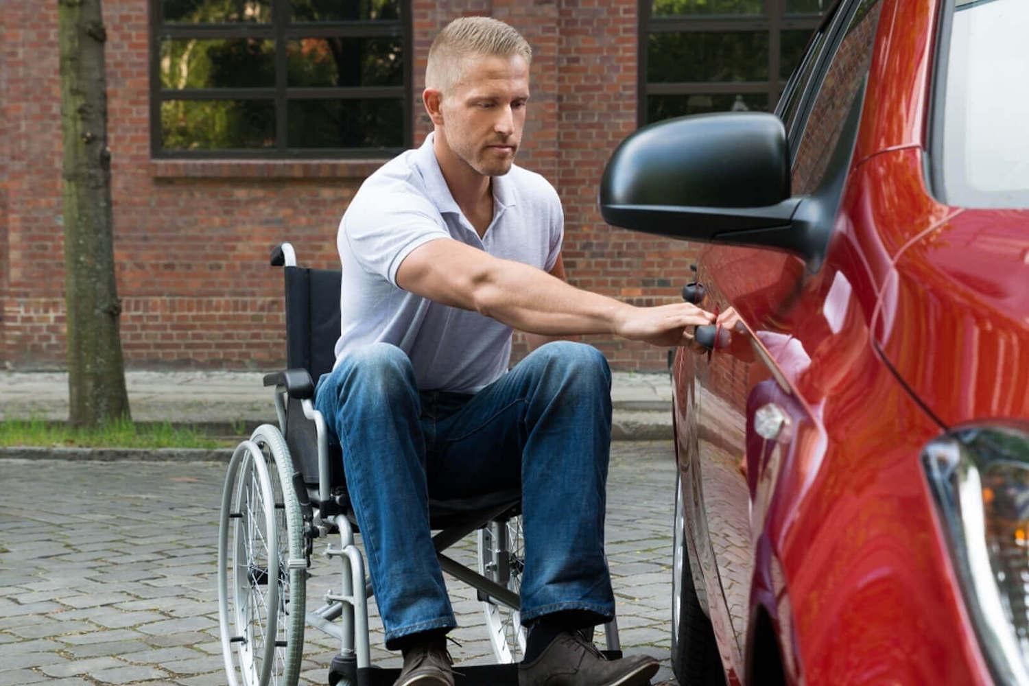 Image of man in wheelchair getting into a car