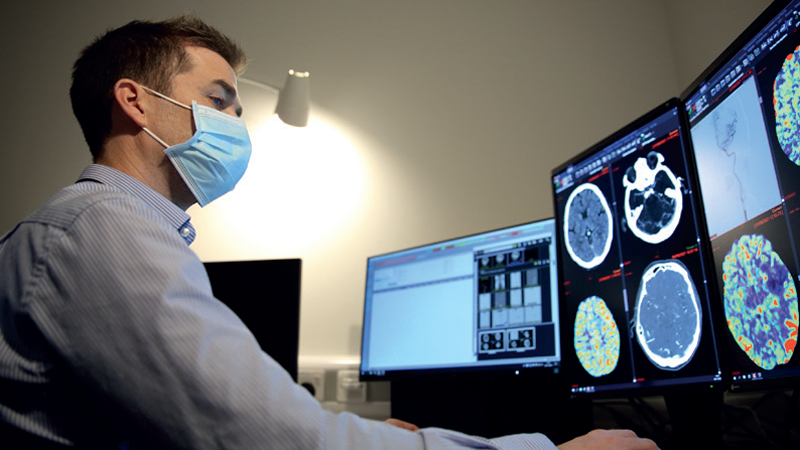 Doctor looking at brain scans 