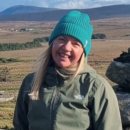 A photo of Chloe Hodgkisson stood outside, smiling at the camera