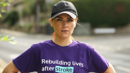 Woman wearing a Stroke Association tshirt looking at the camera