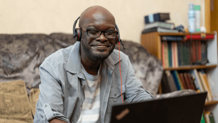 Roger sat in front of his laptop smiling