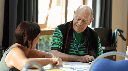 Photo of two people chatting at a stroke group meeting