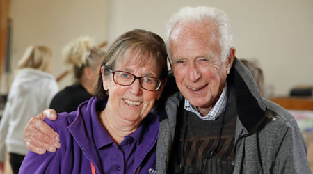 Photo of a volunteer and a support group member, smiling to camera