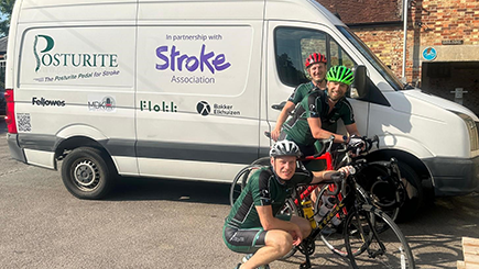 Posturite cyclist team posing in front of white van with stroke association logo